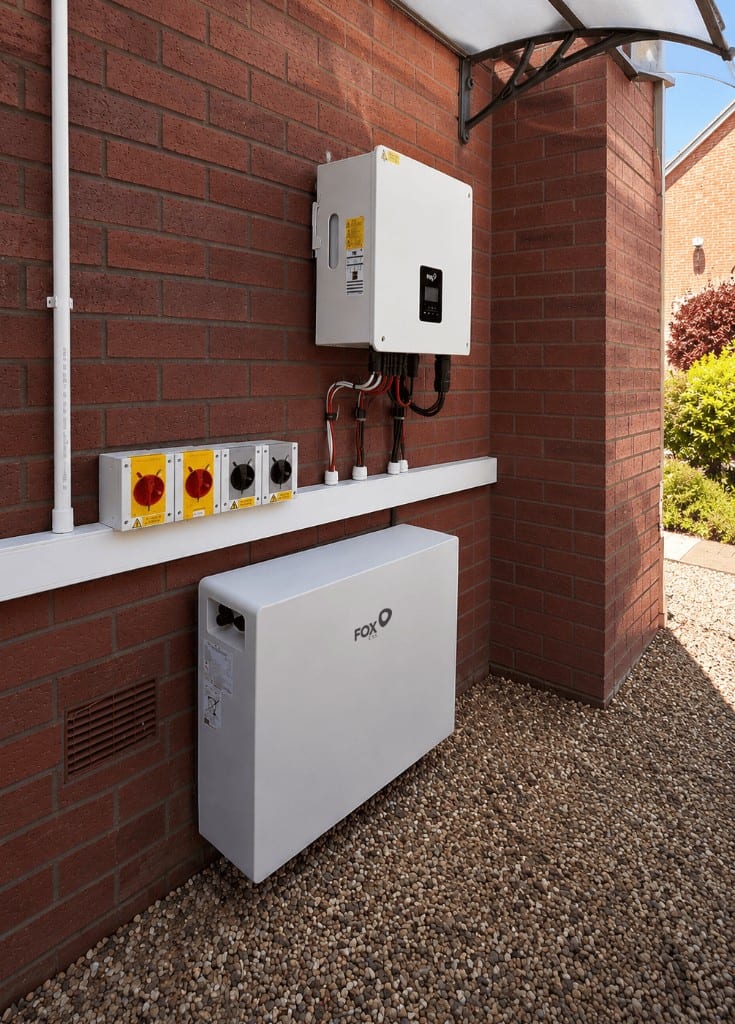Fox ESS EP12 home battery and inverter wall-mounted on the exterior brick wall of a UK home