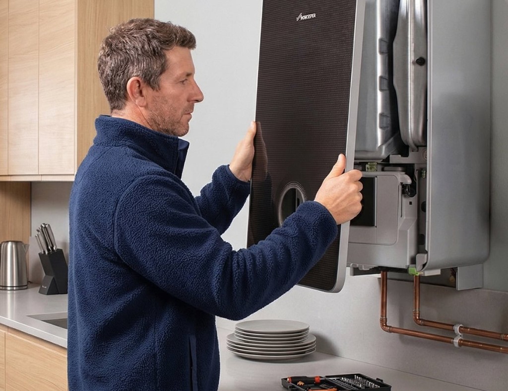 Gas Safe engineer fitting a Worcester Bosch wall-mounted boiler in a modern UK kitchen