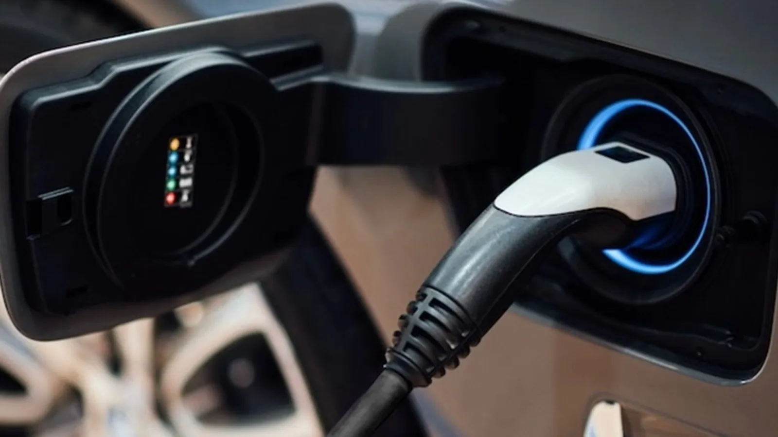 Close-up of a Type 2 charging cable plugged into an electric vehicle's charge port