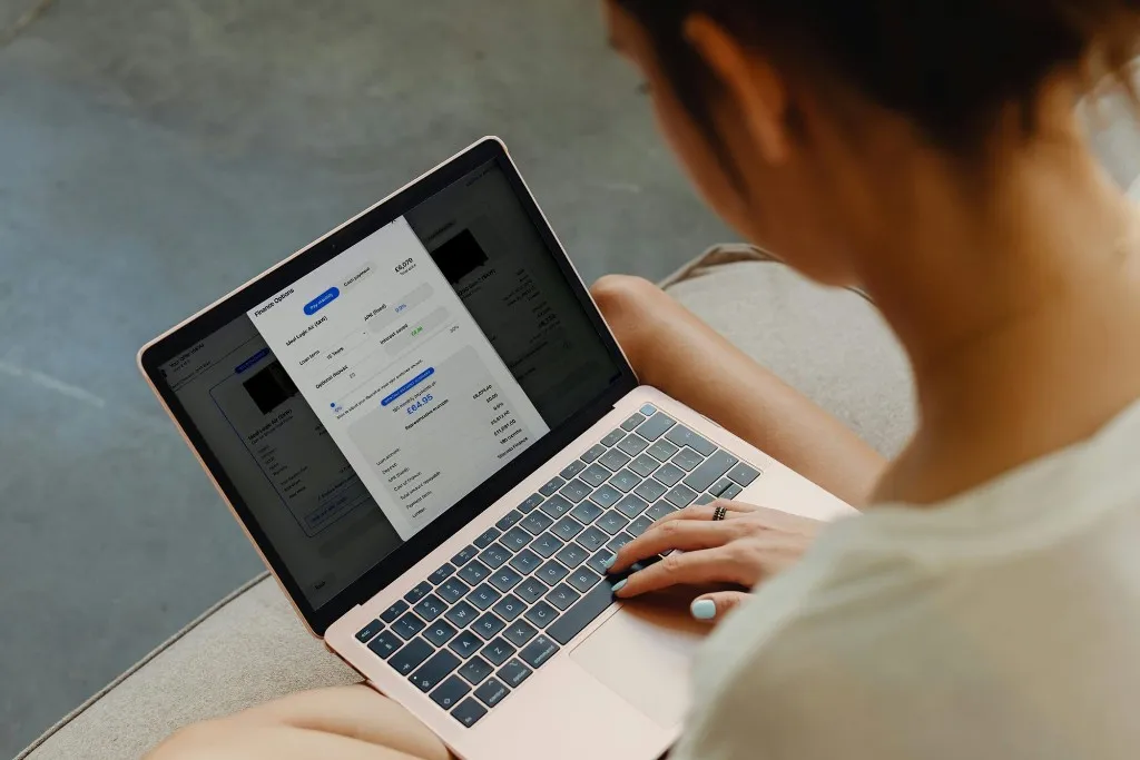 Homeowner reviewing monthly finance options on a laptop
