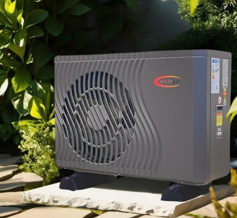Compact 5 kW Trianco Activair air source heat pump installed on a paved base beside a garden border