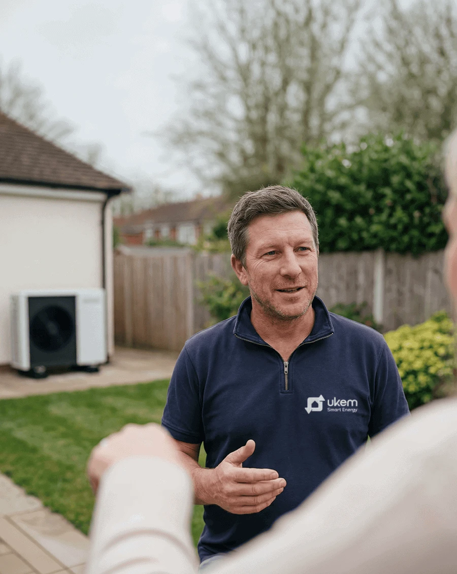 UKEM Smart Energy engineer discussing a heat pump installation with a homeowner