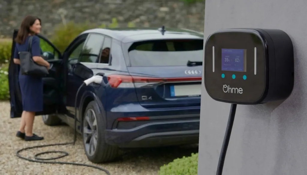Woman with her Audi e-tron and Ohme smart EV charger on a UK driveway