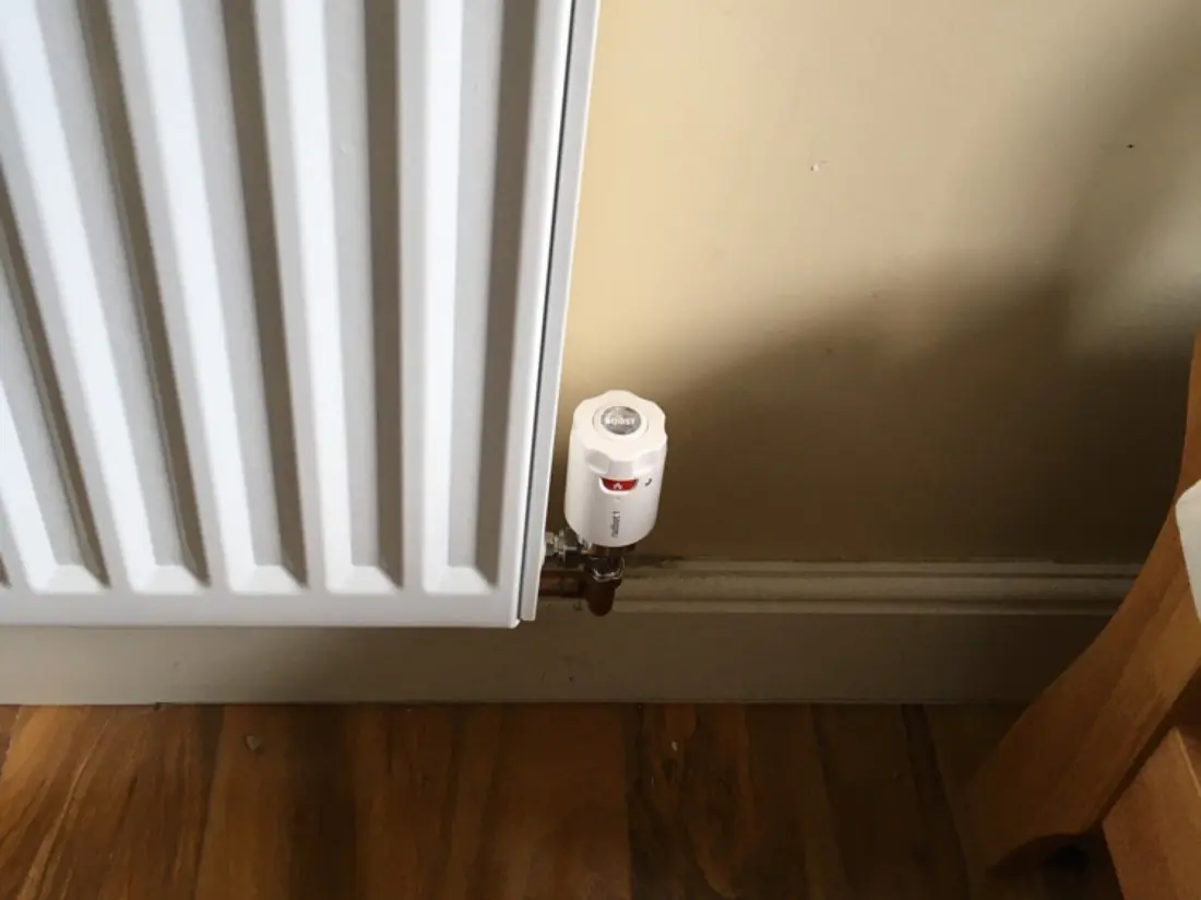 Thermostatic radiator valve fitted on a white panel radiator
