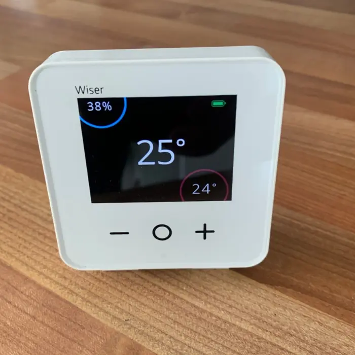 Smart wireless room thermostat showing the room temperature on its colour screen