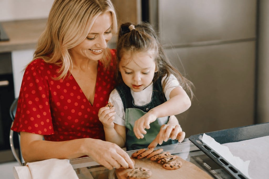 Parent and child baking in a bright UK kitchen during the daytime