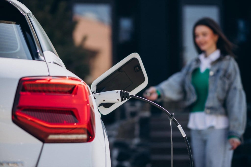 Electric car charging on a UK driveway in daylight